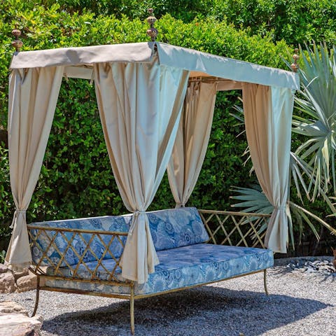 Lounge on the daybed in the shade from the sun and while away the hours surrounded by lush greenery