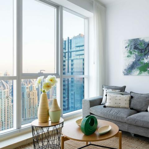 Get cosy on the sofa while enjoying the view out of your floor-to-ceiling windows