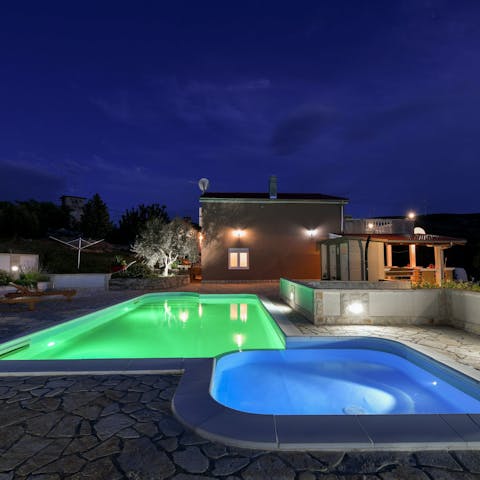 Slip into the illuminated pool for a dip under the stars