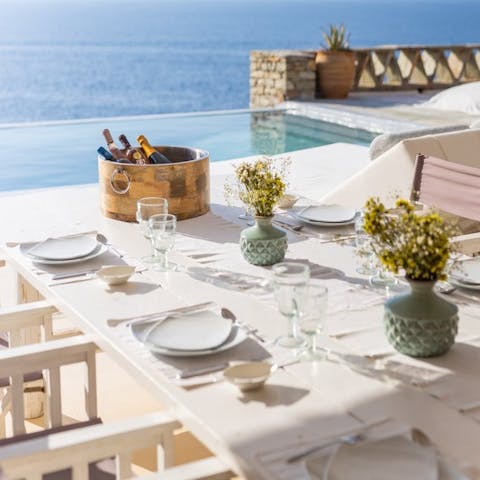 Share delicious feasts and Greek wine on the terrace overlooking the sea 
