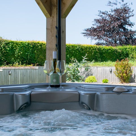 Enjoy a glass of wine in the hot tub as you allow yourself to unwind