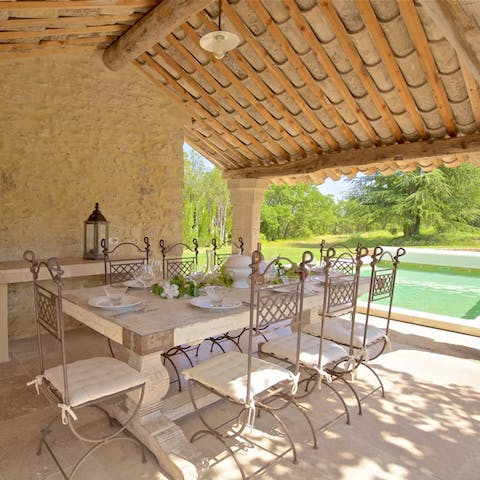 Share memorable meals at the elegant table under the pergola