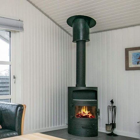 Put a few logs on the wood-burning stove to get cosy in the living space