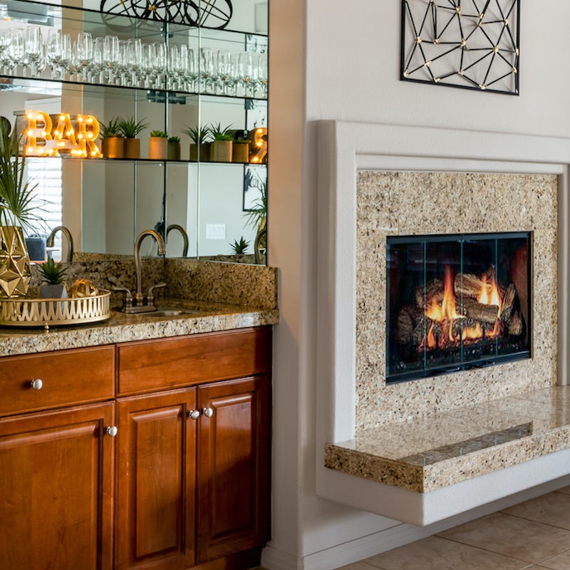 Snuggle up around the electric fireplace with a drink from the bar