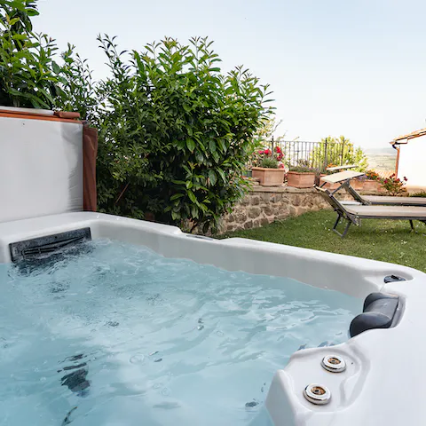 Enjoy a glass of wine and admire views over Montalcino from the hot tub