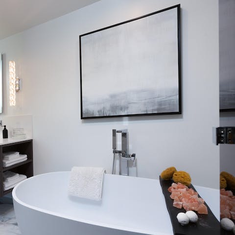 Unwind in the huge free standing bath tub with a glass of California wine in hand 