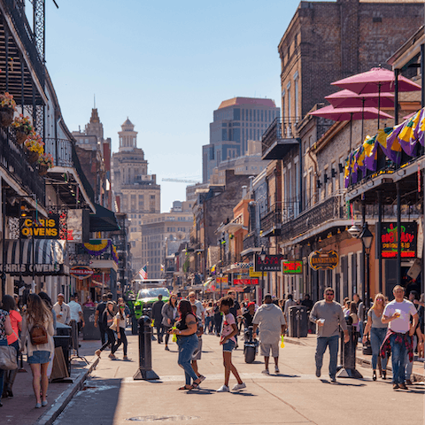 Embrace the frenetic energy of Bourbon Street, a ten-minute drive away