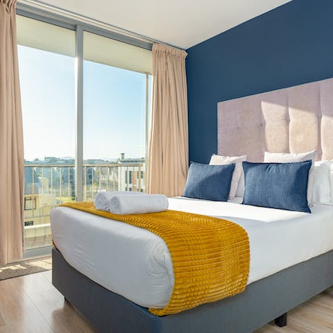 Wake up to sunlight streaming into the plush bedroom
