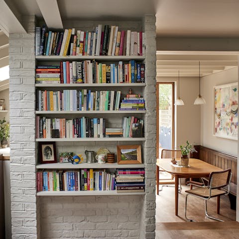 Choose from this wall of books and read sprawled out on the couch