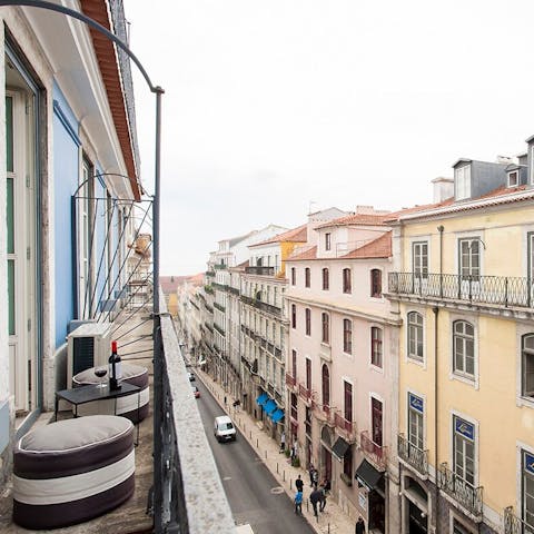Sip Portuguese wine on the balcony as you look out to the streets below