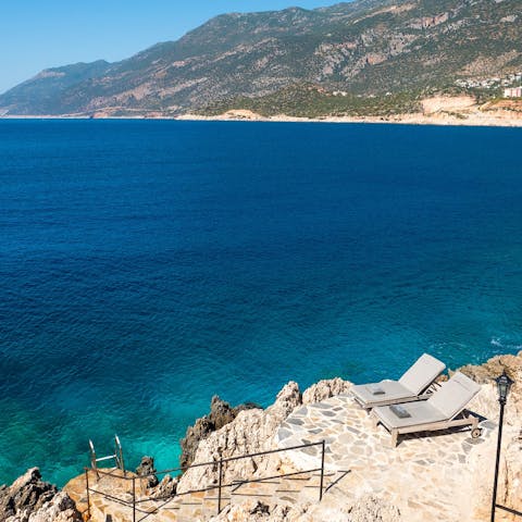 Head down the stone staircase to the private swimming platform