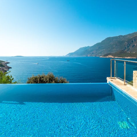 Paddle in the villa's infinity pool and admire the scenery