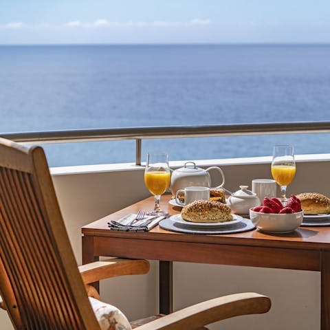 Enjoy breakfast with views over the sea on your private balcony