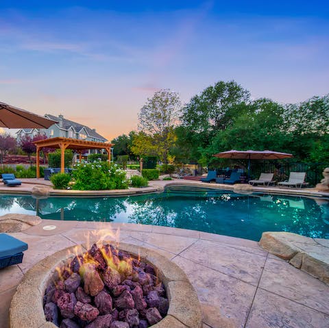 Slip into the pool for an evening swim before heating yourself by the fire
