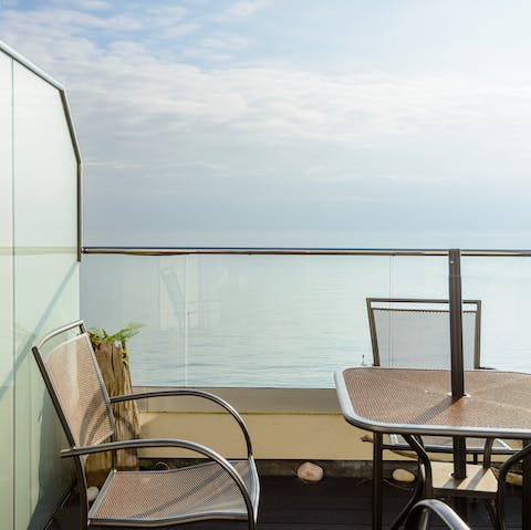Gaze out at the seemingly endless view of blue from one of the apartment's balconies