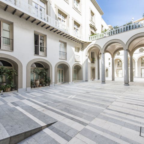 Look out onto the grand courtyard from your Juliet balcony