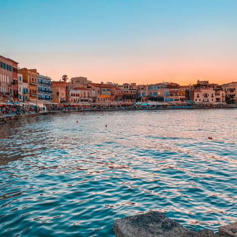 Sip a glass of Cretan wine by the water's edge of Chania's Venetian harbour