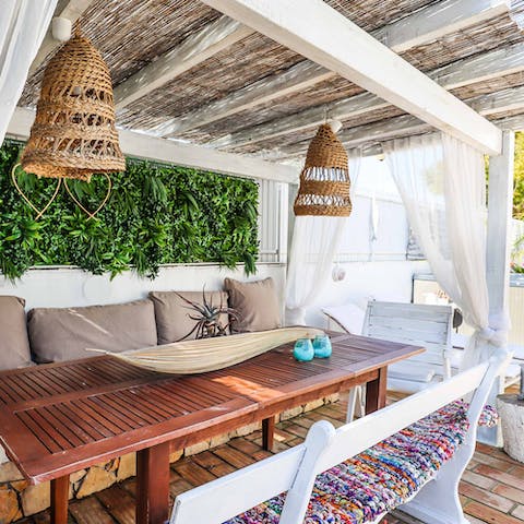Tuck into alfresco family dinners under the pergola