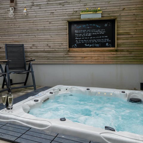 Sink into the bubbling hot tub after a long day of exploring the town and surrounding area, glass of wine in hand