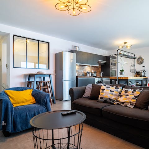Kick back in the bright living area with a glass of French wine after a day of exploring