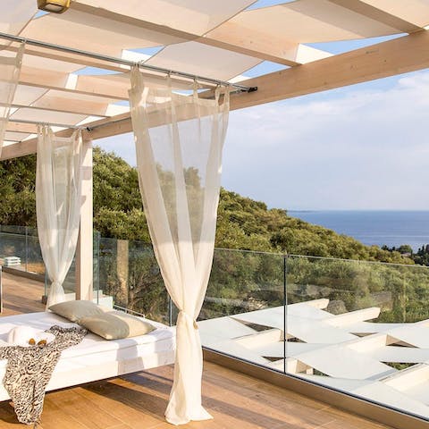 Laze around on the day beds, while soaking up the sparkling views of Aegean Sea 