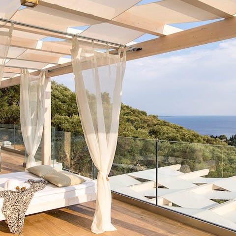 Laze around on the day beds, while soaking up the sparkling views of Aegean Sea