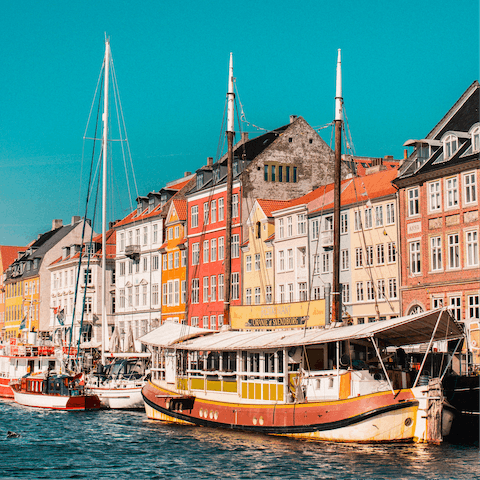 Grab a table by the water's edge for an hour of pints and people-watching in Nyhavn – it's just half a kilometre away