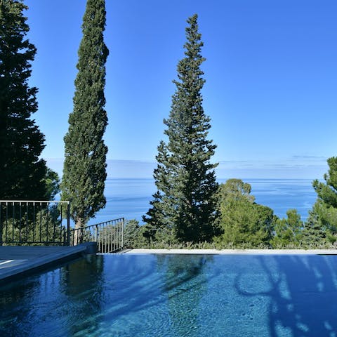 Swim with a view of the glimmering sea in the infinity pool