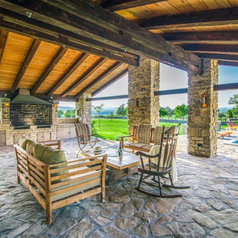 Relax on the covered terrace as you soak up the countryside views