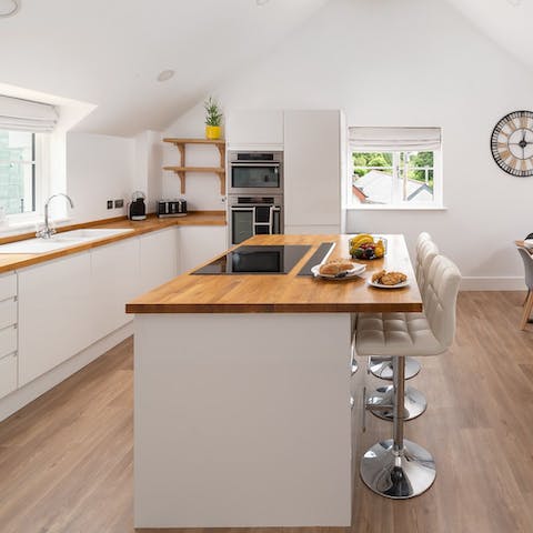 Prepare delicious meals in the large kitchen and gather round the breakfast bar for snacks and nibbles