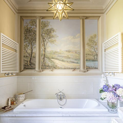 Soak away the day in the tub beneath the frescoes