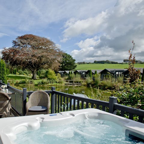 Relax in the private hot tub with a glass of wine as you gaze out over the lake