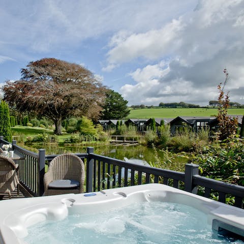 Relax in the private hot tub with a glass of wine as you gaze out over the lake