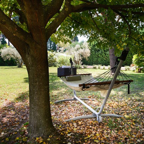 Lie in a hammock under the trees