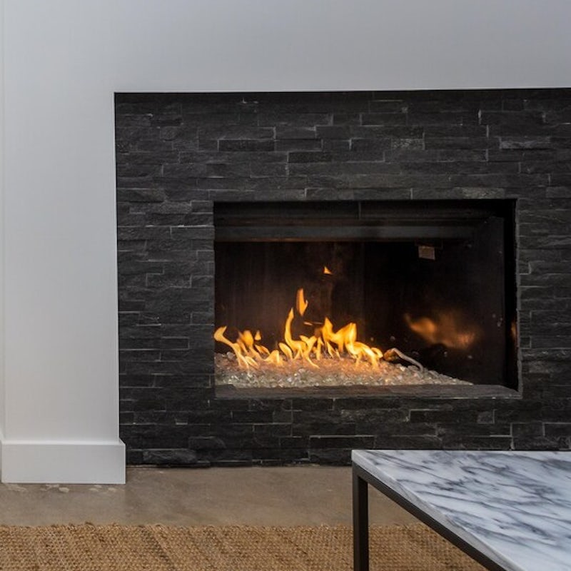 Cosy up by the fireplace after a day by the pool