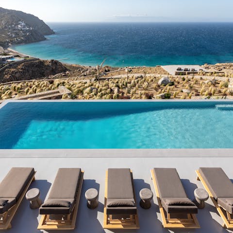 Kick back and relax by the pool, looking out over this unspoiled stretch of coast