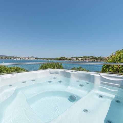 Relax in the hot tub with a glass of wine as you drink in the sea views
