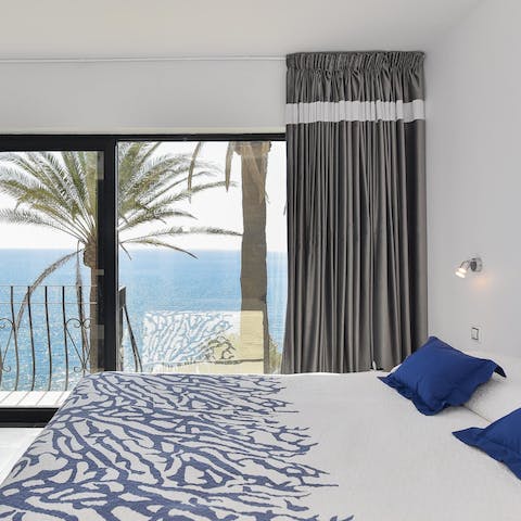 Wake up to the sight of the sea in the sleek bedroom