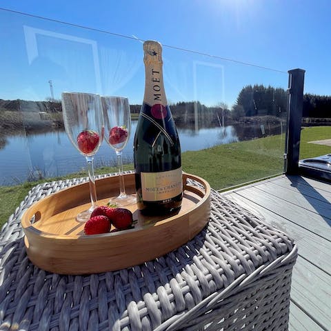 Sip champagne on the terrace overlooking the fishing lake 