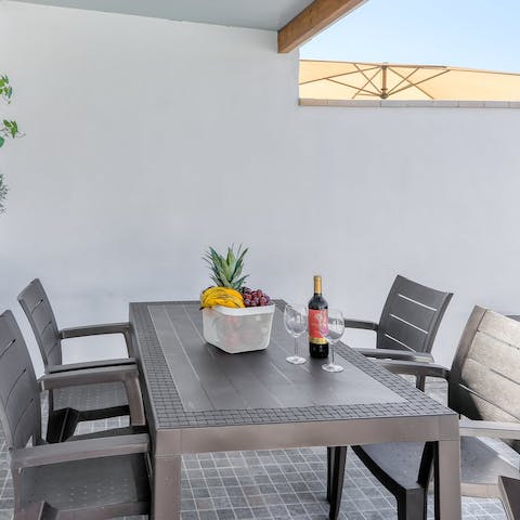 Set the table ready for lunch as local produce sizzles on the barbecue