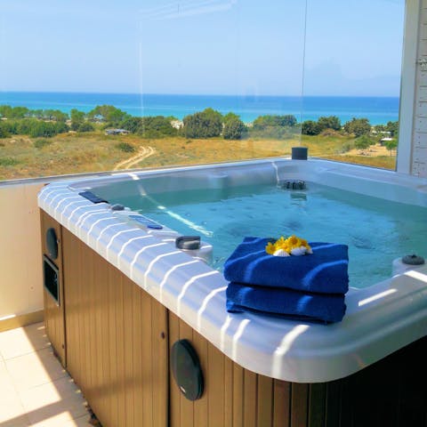 Bubble away in the hot tub, admiring the views across the Aegean Sea
