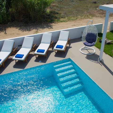 Splash about in the sparkling pool or relax in the lounge chairs with a cocktail or two