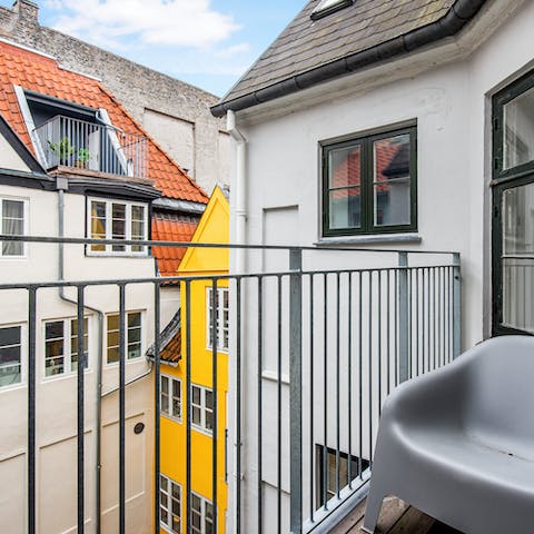 Sip your morning coffee on the private balcony, nestled among classic Danish buildings