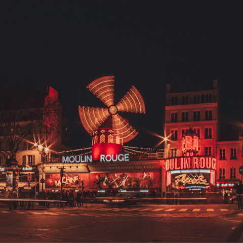 Take a short stroll to Moulin Rouge to see Paris come to life at night