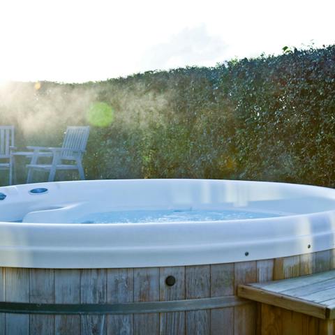 Soak the stress away in the hot tub, glass of bubbly in hand