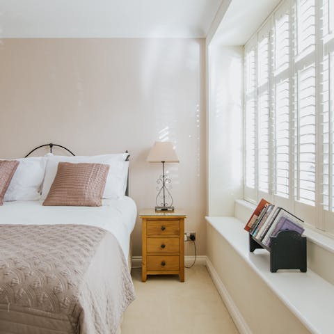 Wake up with the sun shinning through the traditional wooden shutters