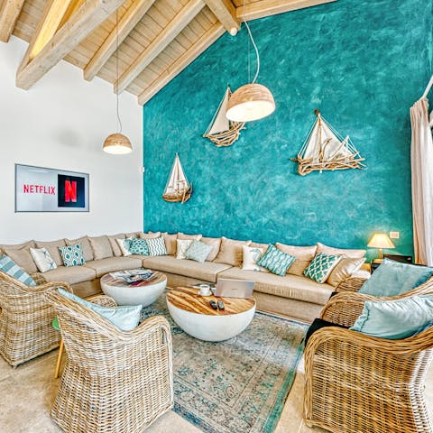 Get together on the huge corner sofa by the wall that shimmers like the sea