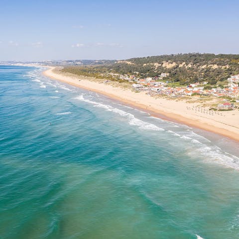 Make the short drive to Praia Fonte da Telha beach 