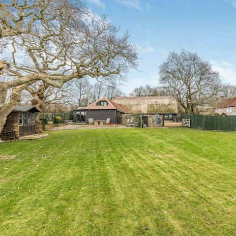 Watch little ones enjoy a runabout on the lawns of the south west-facing garden
