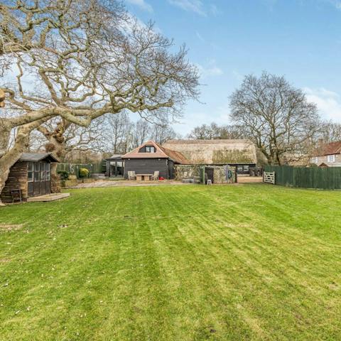 Watch little ones enjoy a runabout on the lawns of the south west-facing garden 